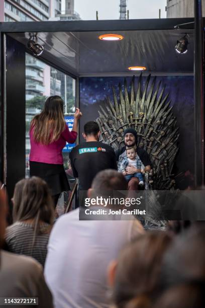 sitting on the game of thrones iron throne in são paulo - game of thrones iron throne stock pictures, royalty-free photos & images