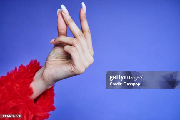 colourful studio portrait of a young woman's hand - clicking fingers stock pictures, royalty-free photos & images