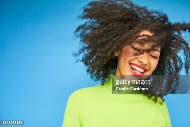 colourful studio portrait of a young woman dancing - toothy smile stock pictures, royalty-free photos & images