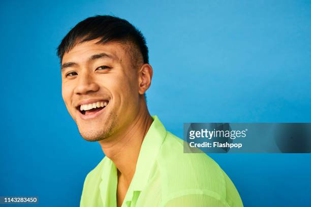 colourful studio portrait of a young man - asian man portrait stock pictures, royalty-free photos & images