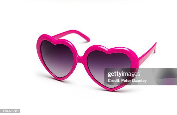 heart shaped sunglasses on white background - sunglasses foto e immagini stock