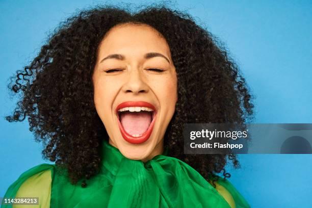 colourful studio portrait of a young woman - mundraum stock-fotos und bilder