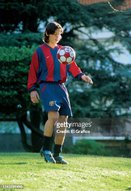 Lionel Messi controls the ball during a private photo session for El Gráfico magazine on October 12, 2003 in Rosario, Argentina.