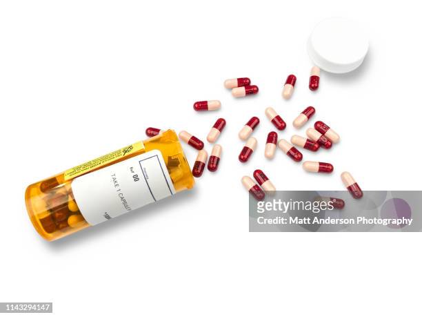 rx pharmacy prescription bottle of pills on white - rx stockfoto's en -beelden