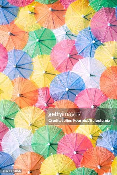 multicolored cocktail umbrellas. - drink umbrella stock pictures, royalty-free photos & images