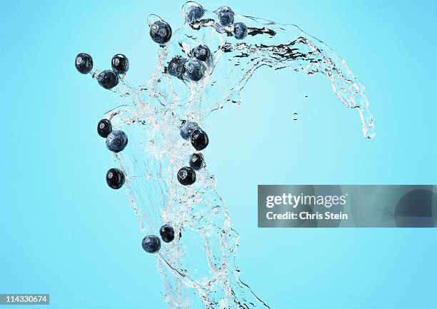 big blueberry water wave on blue - blueberries fruit stock pictures, royalty-free photos & images