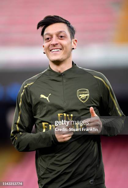 Mesut Ozil of Arsenal looks on during an Arsenal training session ahead of their UEFA Europa League quarter-final second leg match against SSC...