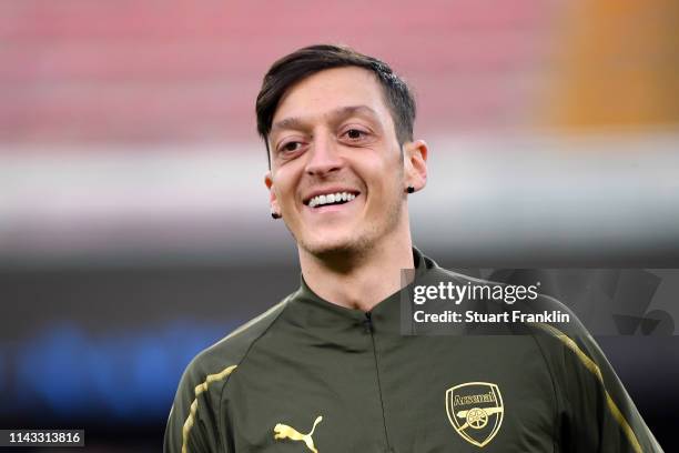 Mesut Ozil of Arsenal looks on during an Arsenal training session ahead of their UEFA Europa League quarter-final second leg match against SSC...