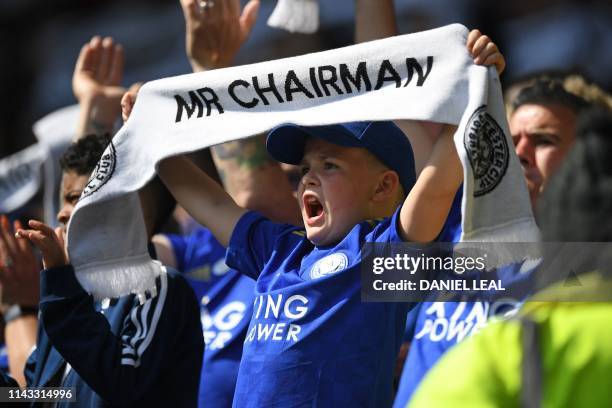 Young Leicester City fan holds up his scarf in the crowd during the English Premier League football match between Leicester City and Chelsea at King...