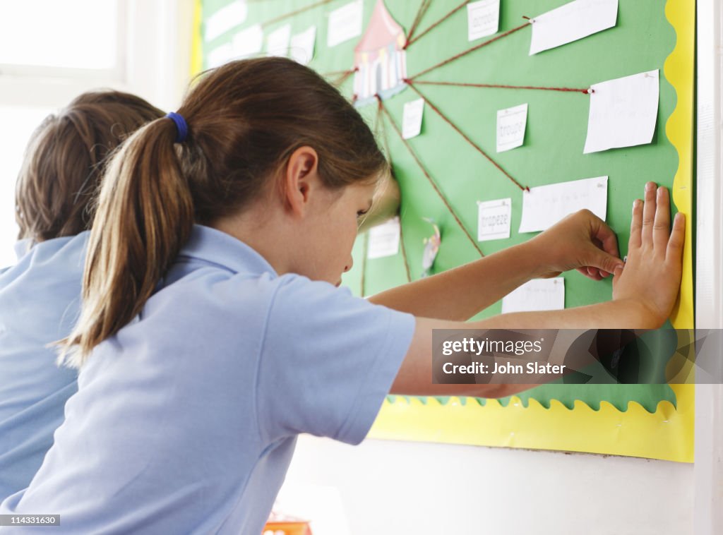 Pin For Kid Using Schoolgirl Pinning Item To Pin Board High-Res Stock Photo - Getty Images
