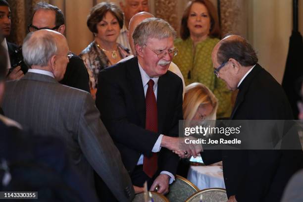 National Security Advisor John R. Bolton greets Ernesto Fernandez Travieso after speaking during the Bay of Pigs Veterans Association luncheon at the...