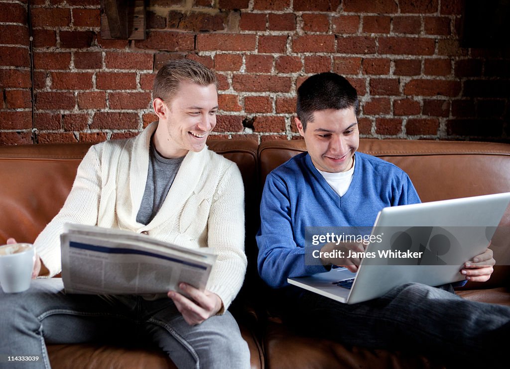 Friends look at laptop in Coffee Shop/Apartment