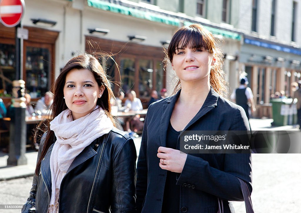 Two female friends walking down the street