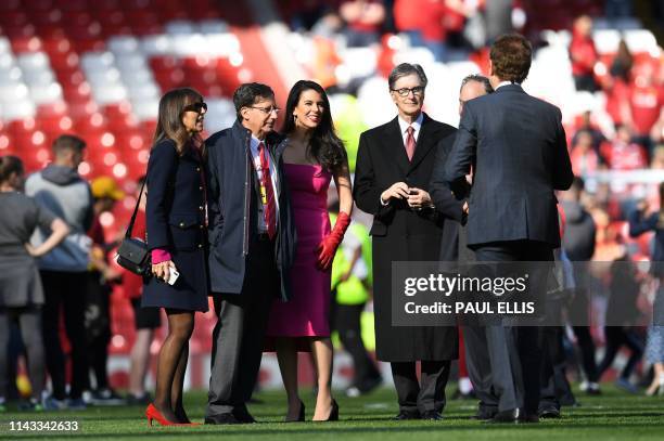 Liverpool Chairman Tom Werner , Liverpool's US owner John W. Henry and Linda Pizzuti , Henry's wife, are seen on the pitch at the end of the English...