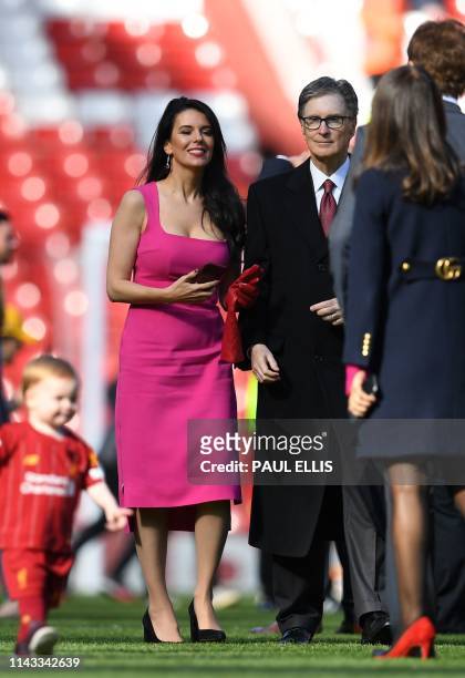Liverpool's US owner John W. Henry and Linda Pizzuti , Henry's wife, are seen on the pitch at the end of the English Premier League football match...