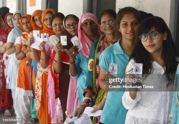 Voters wait outside a polling booth to cast their votes during the sixth phase of Lok Sabha elections 2019, at Badshahpur on May 12, 2019 in...