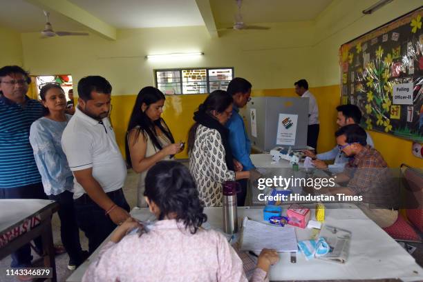 Voters stand in queue to cast their votes at a polling station during the sixth phase of Lok Sabha elections at Greater Kailash on May 12, 2019 in...