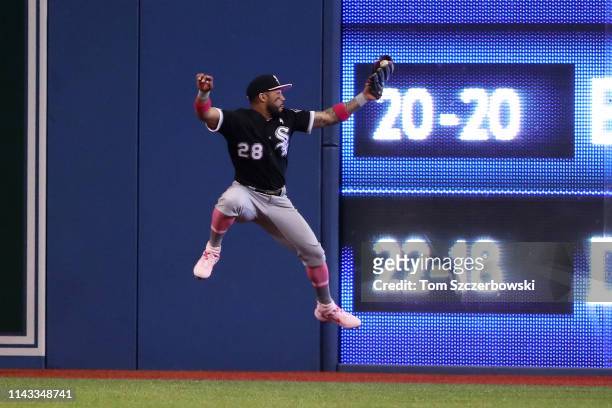 Leury Garcia of the Chicago White Sox catches a fly ball and crashes into the electronic scoreboard on the wall in the third inning during MLB game...
