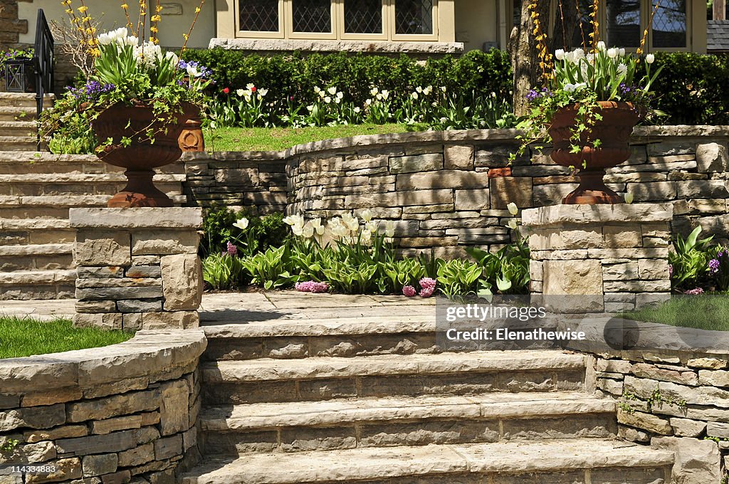 Natural stone landscaping of walls and steps outside house