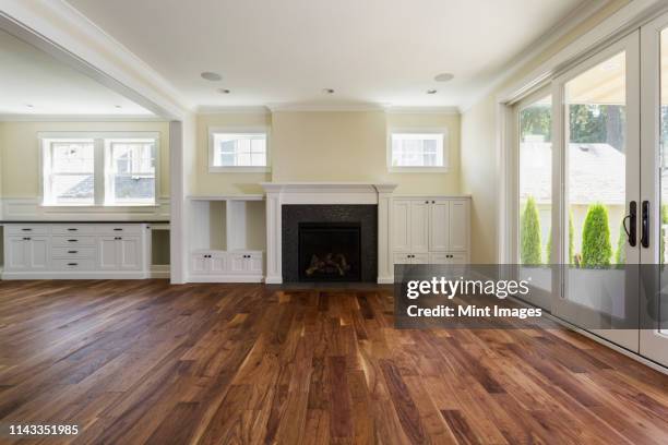 fireplace and built-in shelves in living room - pavimento foto e immagini stock