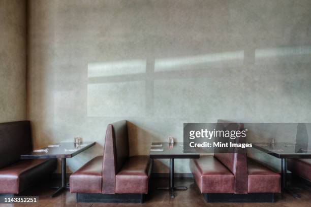 Tables and chairs in empty restaurant