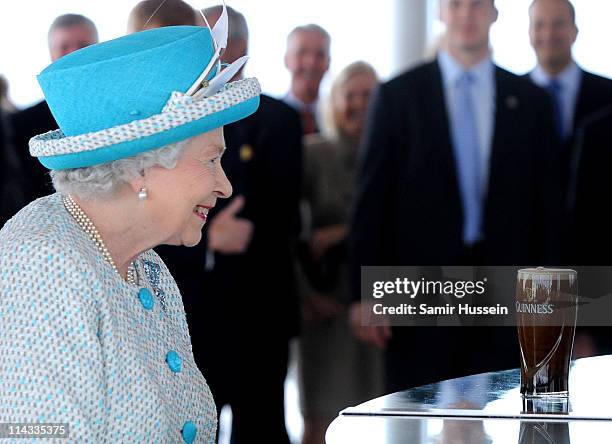 Queen Elizabeth II visits the Guinness Storehouse where she watches the pouring of a pint on May 18, 2011 in Dublin, Ireland. The Duke and Queen's...