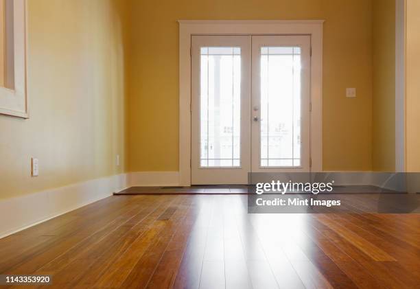 french doors and hardwood floors in new house - french doors stock pictures, royalty-free photos & images