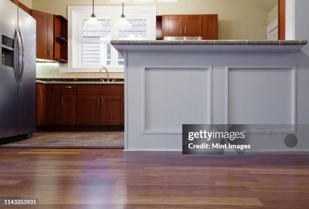 breakfast bar and cabinets in kitchen - floor stock pictures, royalty-free photos & images