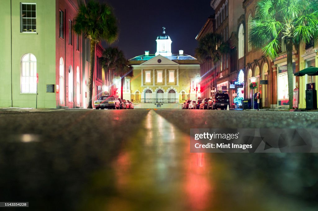 Illuminated buildings along city street at night, Charleston, South Carolina, United States