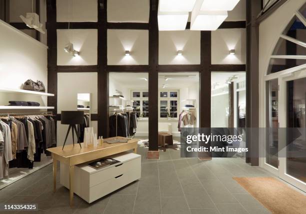 clothes for sale in modern store - clothing store stockfoto's en -beelden