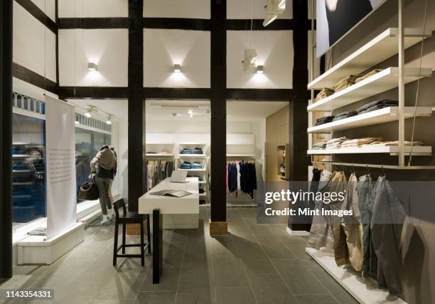 clothes for sale in modern store - kledingwinkel stockfoto's en -beelden