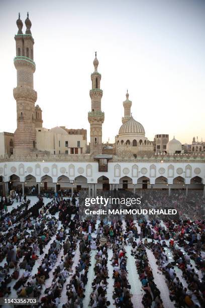 Muslim believers gather before breaking their fast at the Al-Azhar mosque on May 12 as they mark the 1079th anniversary of the establishment of the...