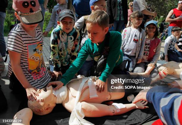 Ukrainian children seen learning about first aid during the festival. Children festival also called City of professions. The festival is a children's...