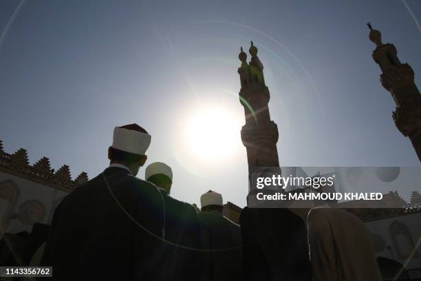 Muslim clerics gather before breaking their fast at the Al-Azhar mosque on May 12 as they mark the 1079th anniversary of the establishment of the...