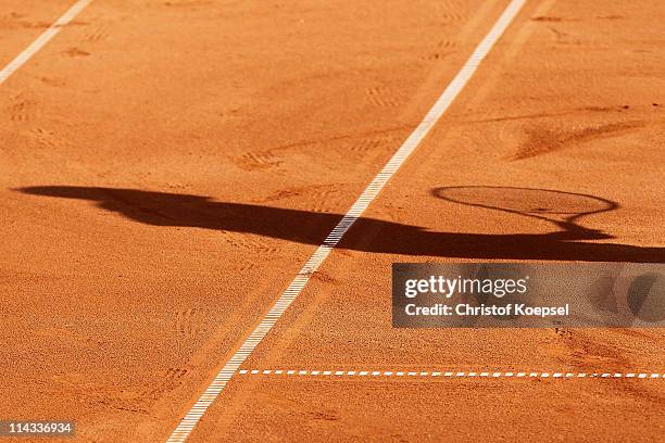 Shadow of a player is seen during the match between Philipp Petzschner and Christopher Kas and Marcel Granollers and Marc Lopez of Spain in the blue...