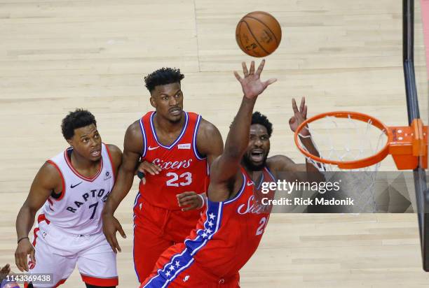 Toronto Raptors guard Kyle Lowry and Philadelphia 76ers guard Jimmy Butler have eyes as Philadelphia 76ers center Joel Embiid finishes. Toronto...