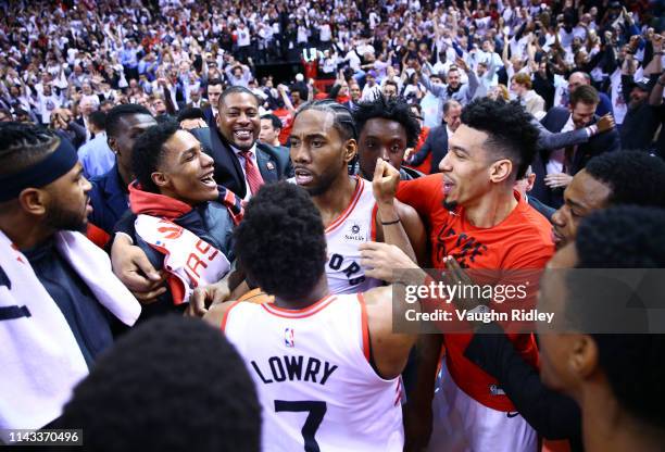 Kawhi Leonard of the Toronto Raptors celebrates with teammates after sinking a buzzer beater to win Game Seven of the second round of the 2019 NBA...