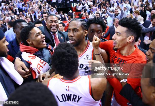 Kawhi Leonard of the Toronto Raptors celebrates with teammates after sinking a buzzer beater to win Game Seven of the second round of the 2019 NBA...