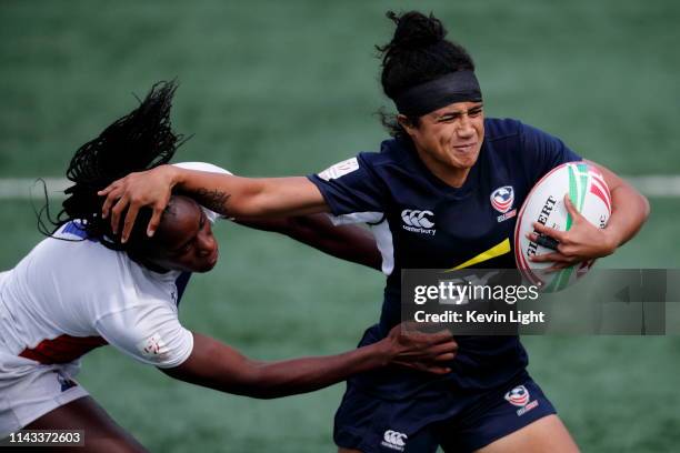 Joanne Fa'avesi of the USA runs with the ball while being chased by Seraphine Okemba of France during the HSBC World Rugby Sevens Series Bronze medal...