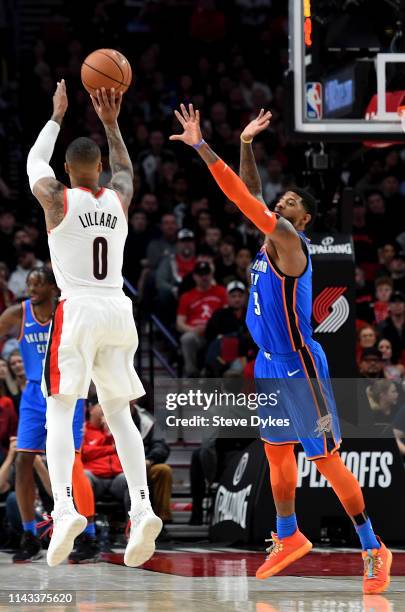 Damian Lillard of the Portland Trail Blazers shoots the ball over Paul George of the Oklahoma City Thunder in the first quarter of Game One of the...