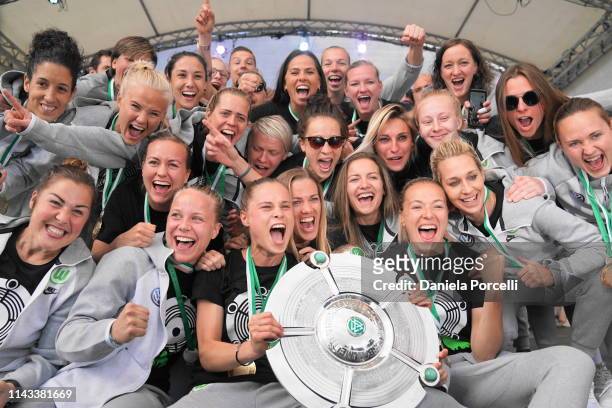 Wolfsburg players celebrate with the championship trophy on the after party with the fans after the Allianz Frauen-Bundesliga football match between...