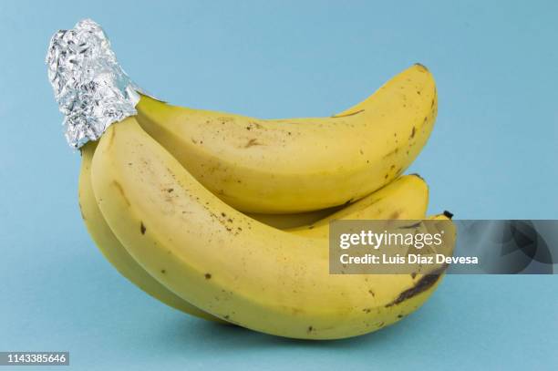 banana protected with foil - foil wrapped stock pictures, royalty-free photos & images