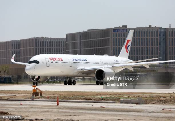 China Eastern Airlines Airbus A350-900 taxis at the new Beijing Daxing International Airport in Beijing on May 13, 2019. - Chinese airlines conducted...