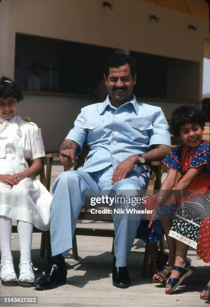 Iraq president Saddam Hussein sits with his daughters Raghad and Rana at the lakeside holiday resort of Habbaniyah in Central Iraq, circa 1977;