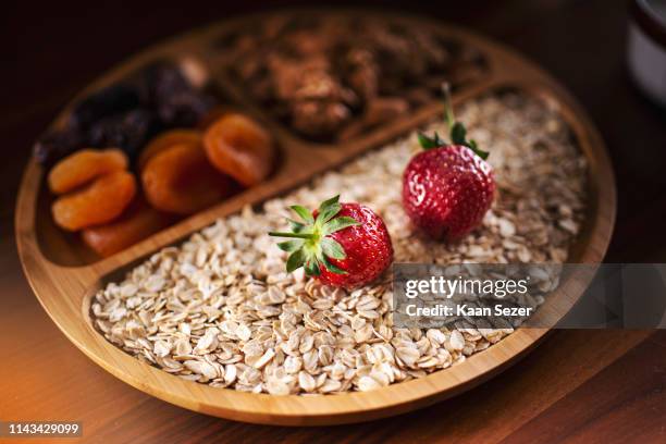 Healthy Breakfast Bamboo Bowl With Granola Strawberry Walnut Almonds Dry Fruits And Yogurt Diet And Vegetarian Food Concept High-Res Stock Photo