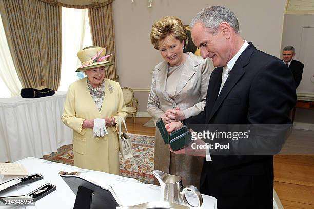 Queen Elizabeth II with President Mary McAleese and Dr. Martin McAleese at the exchange of gifts at Farmleigh on May 18, 2011 in Dublin, Ireland. The...