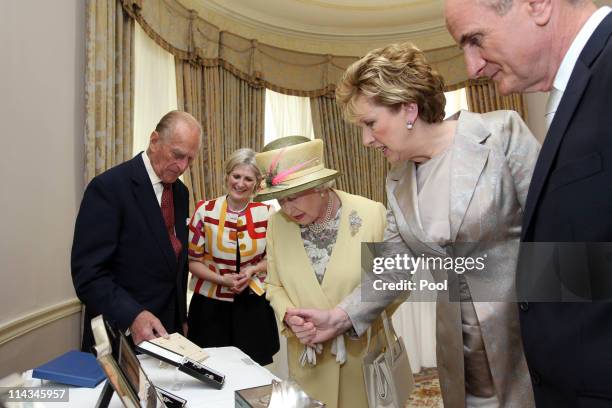 Mary Heffernan, General Manager of National Historic Properties, President Mary McAleese and Dr. Martin McAleese present Queen Elizabeth II and...