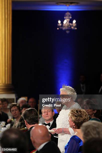 Queen Elizabeth II makes a speech watched by Irish Taoiseach Enda Kenny and President Mary McAleese during a State Dinner at Dublin Castle, on May...