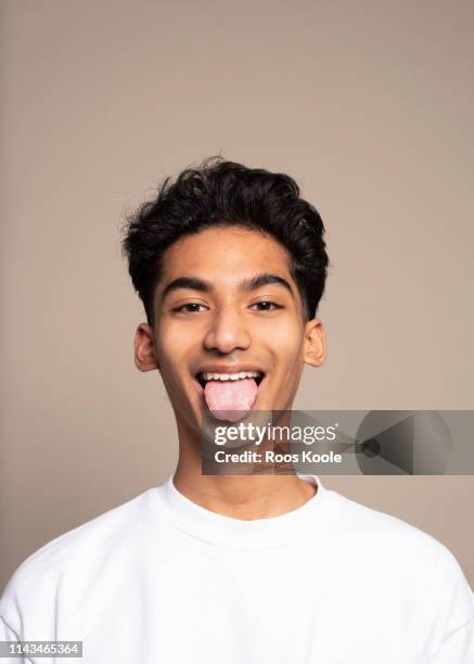 portrait of a young man - tong uitsteken stockfoto's en -beelden