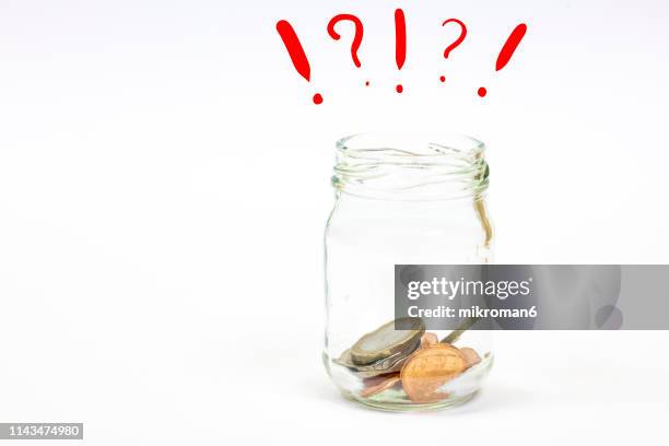 money in a glass jar with exclamation point and question mark - asking money stock pictures, royalty-free photos & images